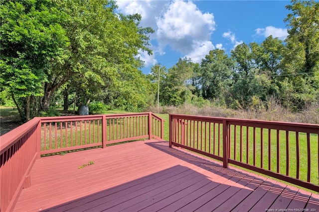 wooden terrace featuring a yard