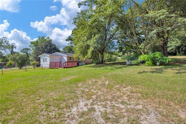 view of yard featuring a wooden deck