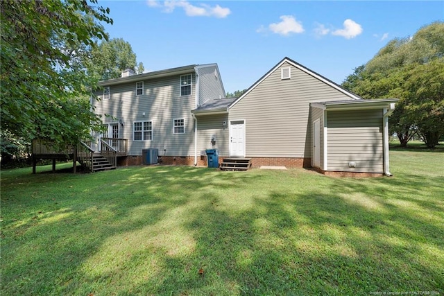 back of property featuring a yard, a deck, and central AC