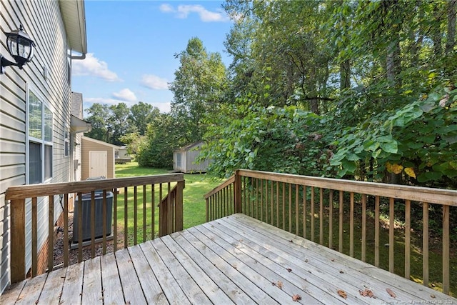 deck featuring a yard and a shed