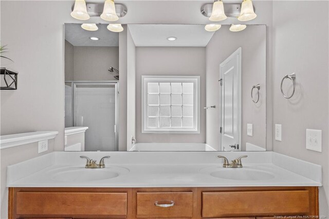 bathroom featuring vanity and a shower with shower door