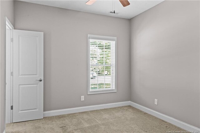 unfurnished room with light colored carpet and ceiling fan