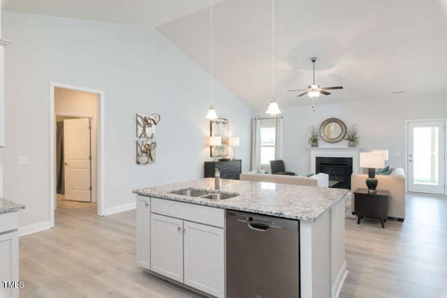 kitchen featuring dishwasher, plenty of natural light, white cabinetry, and light hardwood / wood-style flooring