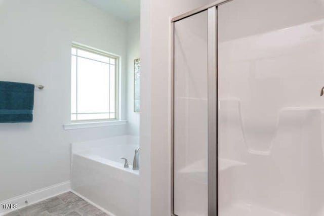 bathroom with shower with separate bathtub