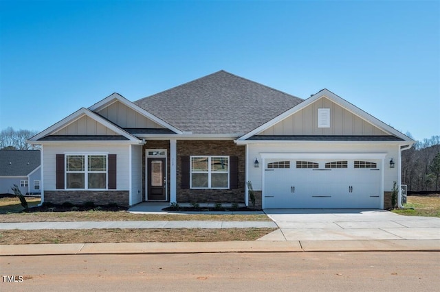 craftsman house featuring an attached garage, concrete driveway, board and batten siding, and stone siding