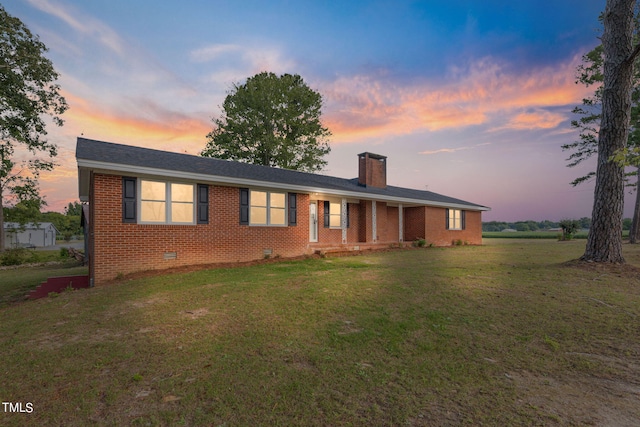 single story home with a lawn