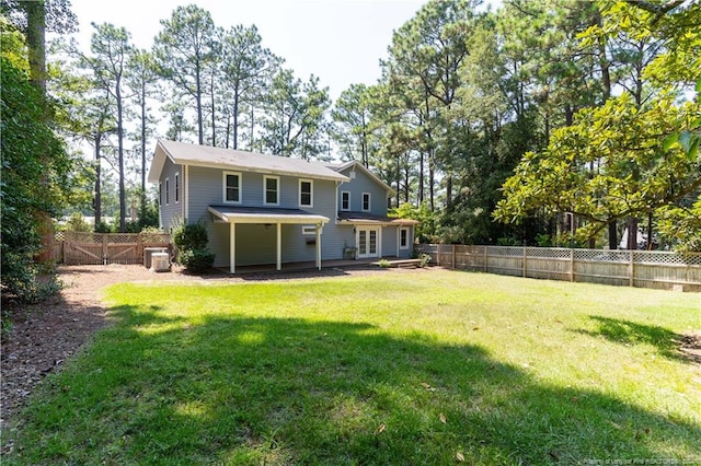 rear view of house with a yard and a patio