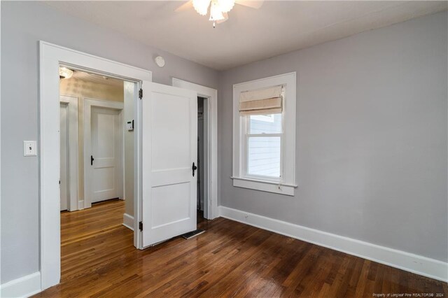 unfurnished bedroom with dark wood-type flooring and ceiling fan