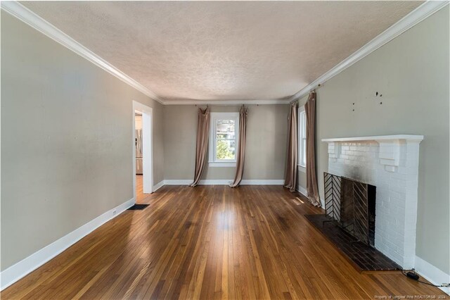 unfurnished living room featuring dark wood-type flooring, a fireplace, crown molding, and a textured ceiling