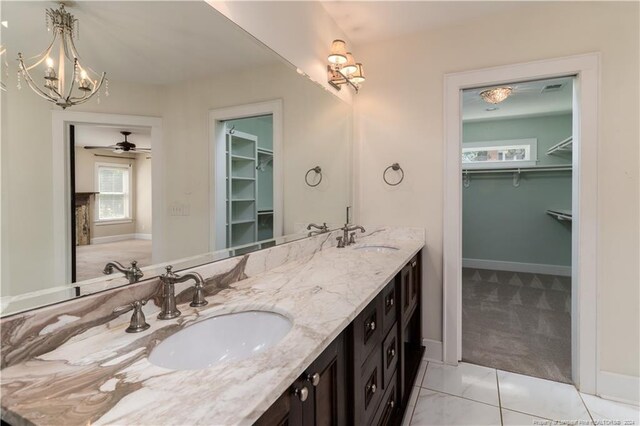 bathroom with tile patterned flooring, ceiling fan, and vanity