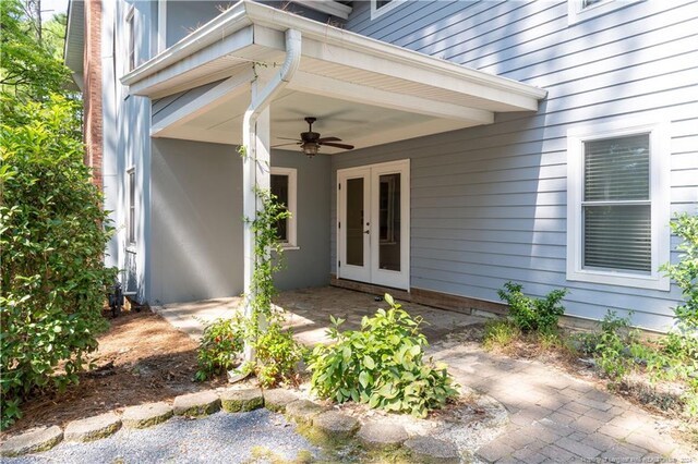 property entrance featuring ceiling fan, a patio area, and french doors