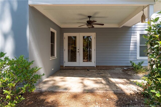 view of exterior entry featuring ceiling fan, a patio, and french doors