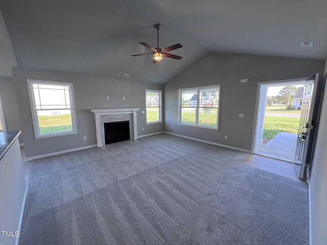 unfurnished living room with lofted ceiling, ceiling fan, and carpet flooring