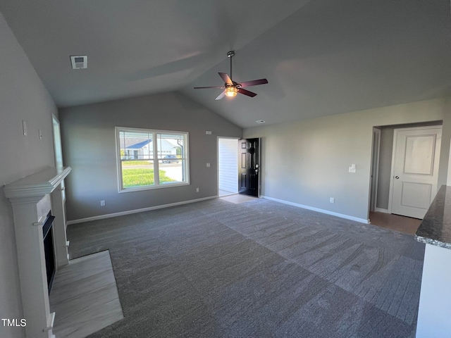 unfurnished living room with carpet flooring, ceiling fan, and vaulted ceiling