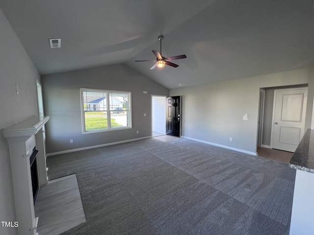 194 Lotus Ave, Smithfield, NC 27577 - unfurnished living room with a fireplace with flush hearth, carpet, baseboards, ceiling fan, and lofted ceiling