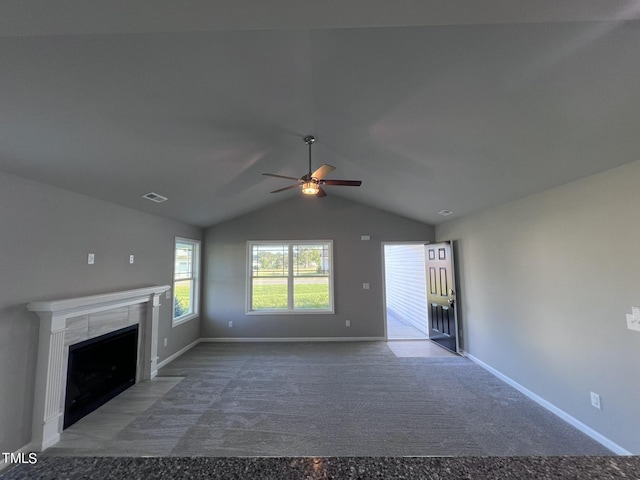194 Lotus Ave, Smithfield, NC 27577 - unfurnished living room with visible vents, a fireplace, a ceiling fan, carpet floors, and vaulted ceiling