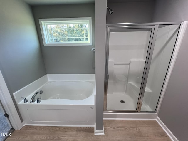 194 Lotus Ave, Smithfield, NC 27577 - full bathroom featuring a bath, baseboards, wood finished floors, and a shower stall