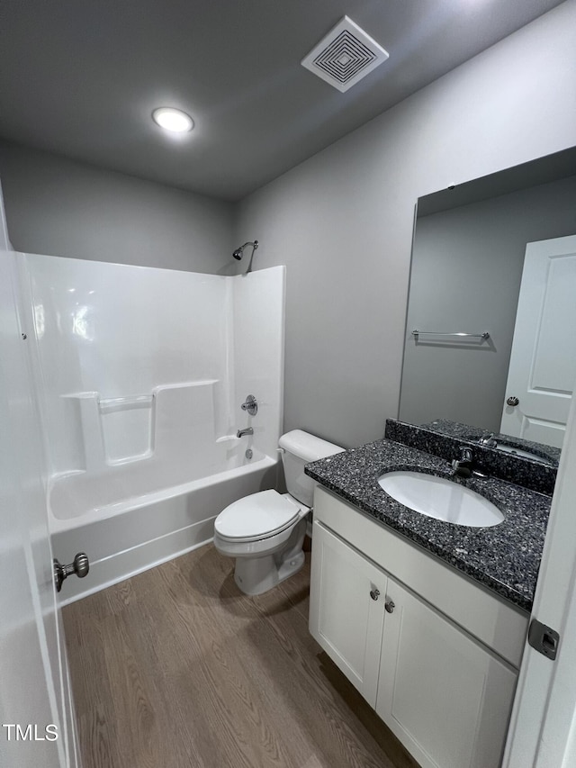194 Lotus Ave, Smithfield, NC 27577 - bathroom with vanity, shower / bath combination, toilet, visible vents, and wood finished floors
