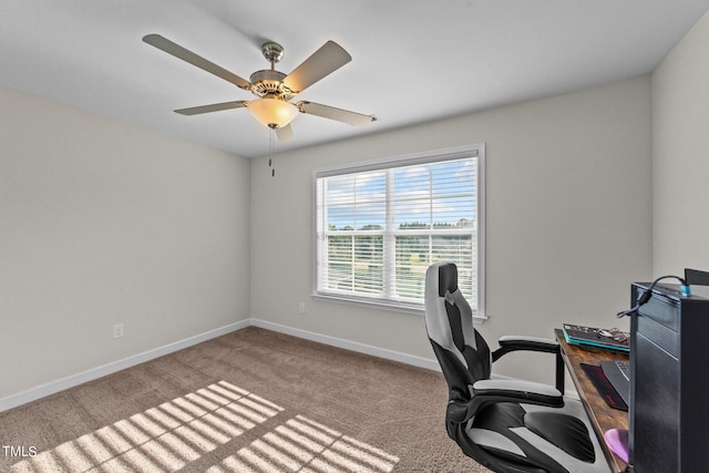 carpeted office space with ceiling fan