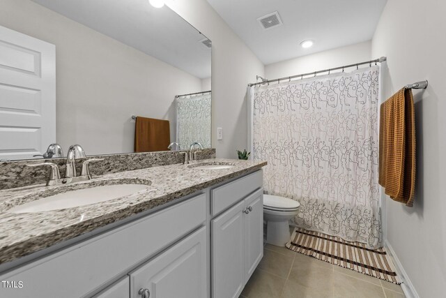 bathroom featuring vanity, toilet, a shower with shower curtain, and tile patterned floors