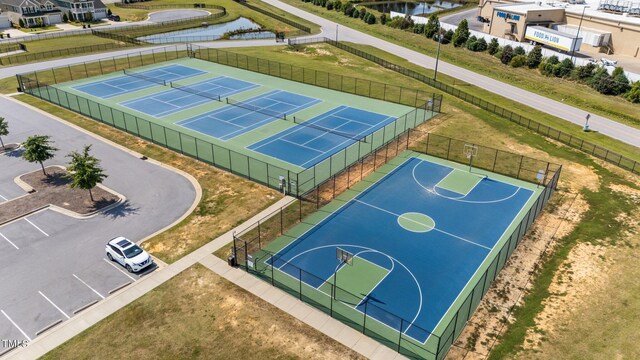 view of basketball court featuring a water view