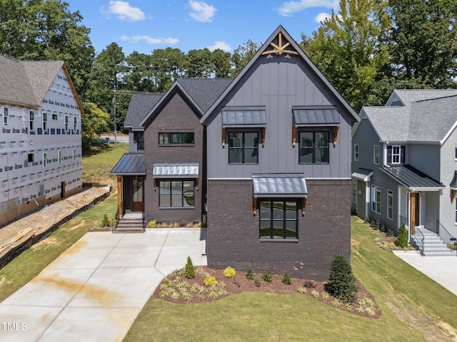 modern farmhouse featuring a front lawn