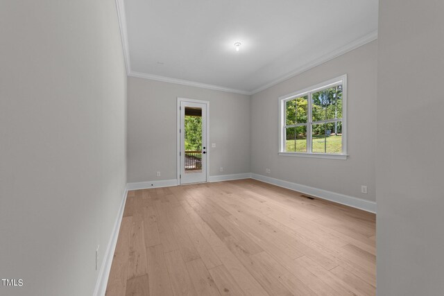 spare room with light hardwood / wood-style flooring and ornamental molding