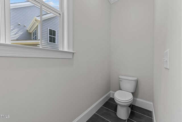 bathroom with tile patterned flooring and toilet