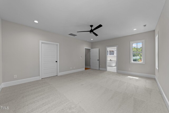 spare room with ceiling fan and light colored carpet