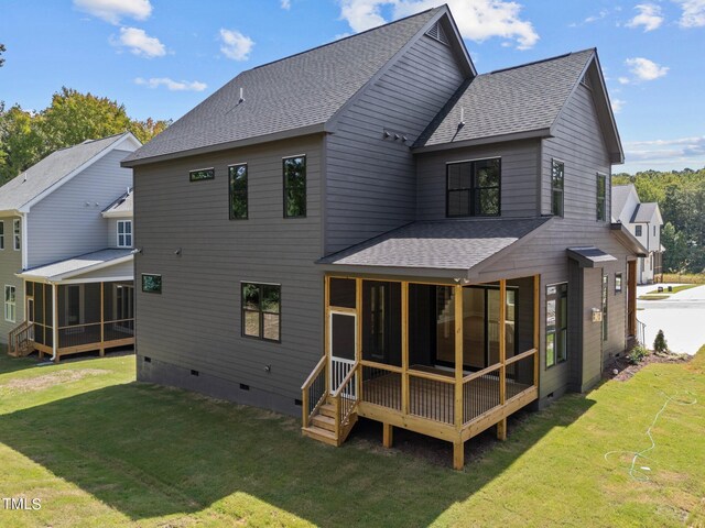 rear view of property featuring a yard and a sunroom