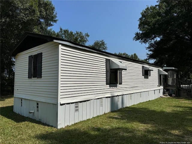 view of side of home featuring a yard and crawl space