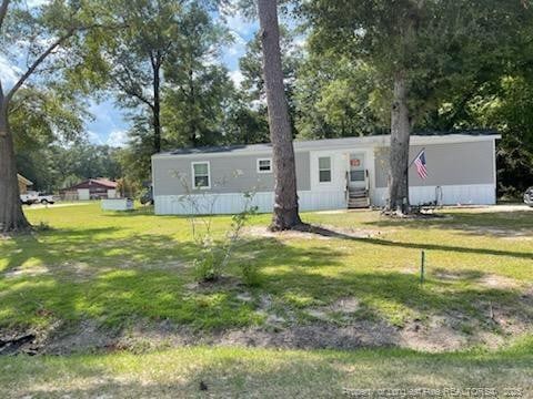 1644 Henry Berry Rd 1642, Rowland, NC 28383 - view of front of property with entry steps, a front lawn, and view of wooded area