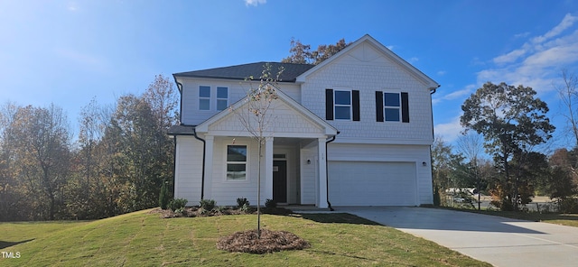 view of front of house with driveway, a front lawn, and an attached garage