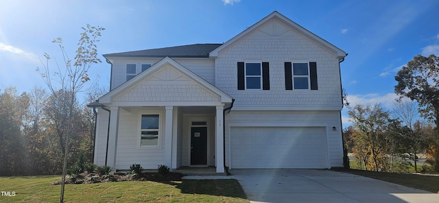 view of front of property with an attached garage, driveway, and a front yard