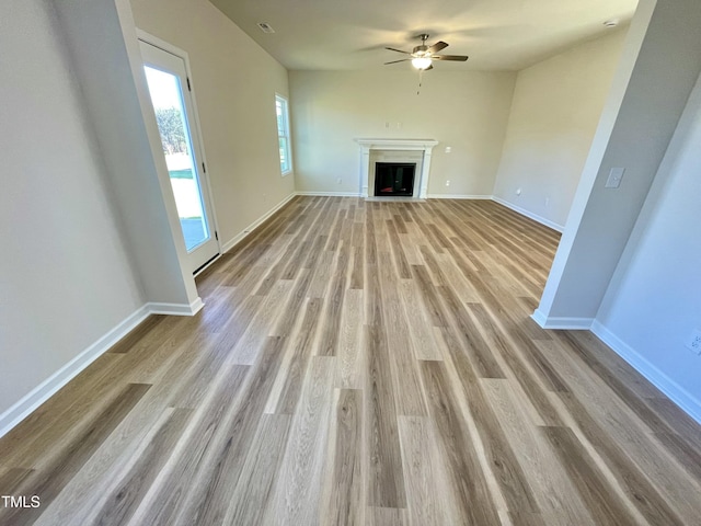 unfurnished living room with ceiling fan and light hardwood / wood-style flooring