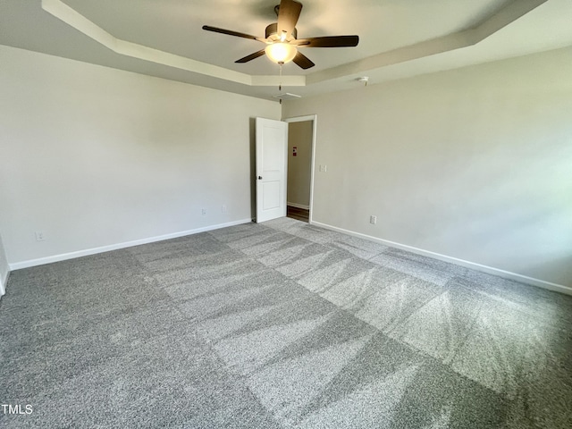 158 Sourgum Ct, Zebulon, NC 27597 - unfurnished room with a tray ceiling, ceiling fan, baseboards, and carpet flooring