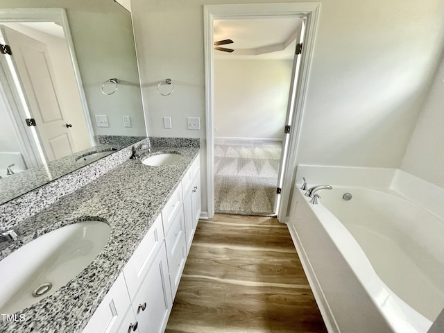 158 Sourgum Ct, Zebulon, NC 27597 - bathroom featuring wood finished floors, a garden tub, and double vanity