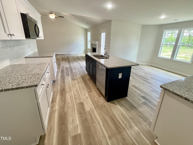 158 Sourgum Ct, Zebulon, NC 27597 - kitchen with open floor plan, light wood finished floors, light stone counters, baseboards, and recessed lighting