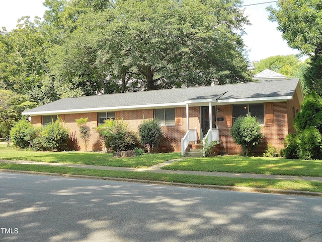 ranch-style home featuring a front yard