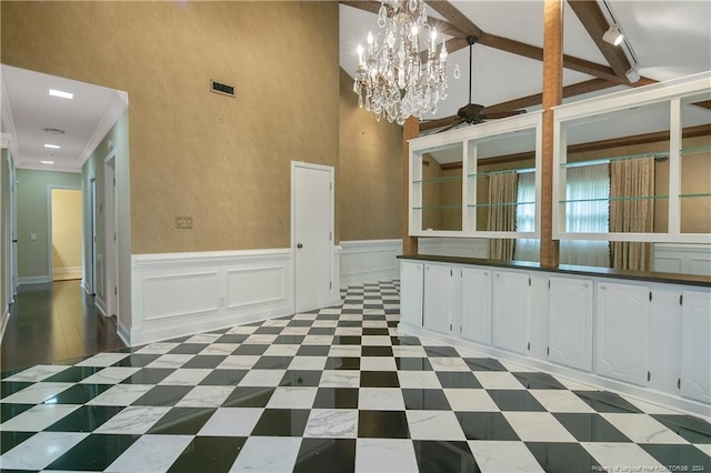 2116 Winterlochen Rd, Fayetteville, NC 28305 - unfurnished dining area with a wainscoted wall, high vaulted ceiling, a decorative wall, ceiling fan with notable chandelier, and track lighting