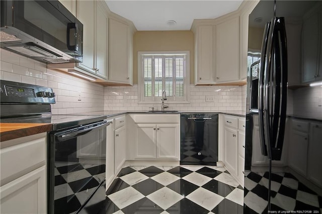 2116 Winterlochen Rd, Fayetteville, NC 28305 - kitchen featuring a sink, backsplash, light floors, butcher block counters, and black appliances