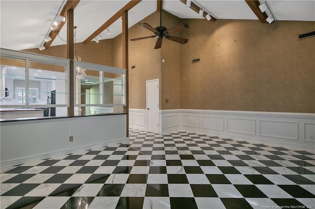 spare room featuring ceiling fan, beamed ceiling, track lighting, and high vaulted ceiling