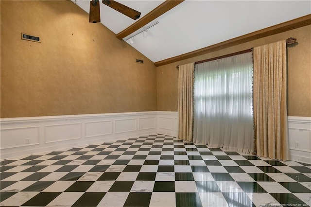 spare room featuring vaulted ceiling, ceiling fan, and track lighting