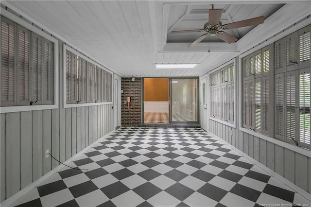 unfurnished sunroom featuring ceiling fan and wooden ceiling