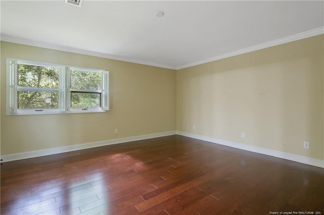 empty room with ornamental molding and dark hardwood / wood-style flooring