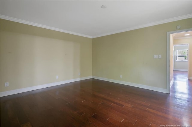 spare room featuring dark hardwood / wood-style floors and ornamental molding