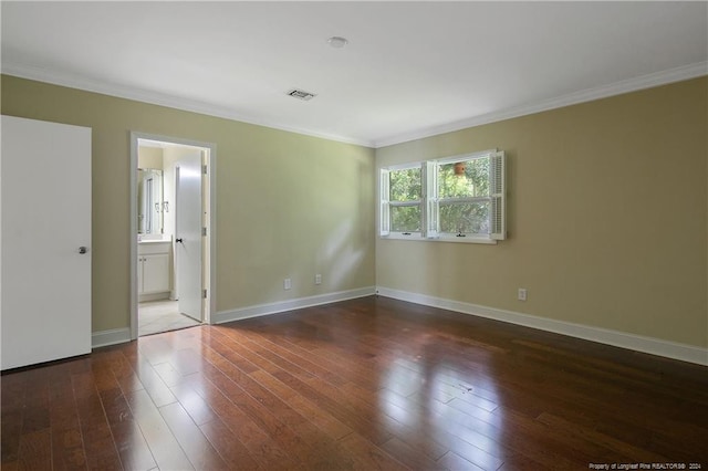 empty room featuring dark wood-type flooring and crown molding