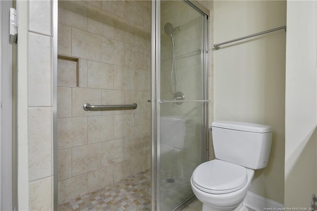 bathroom featuring walk in shower and toilet