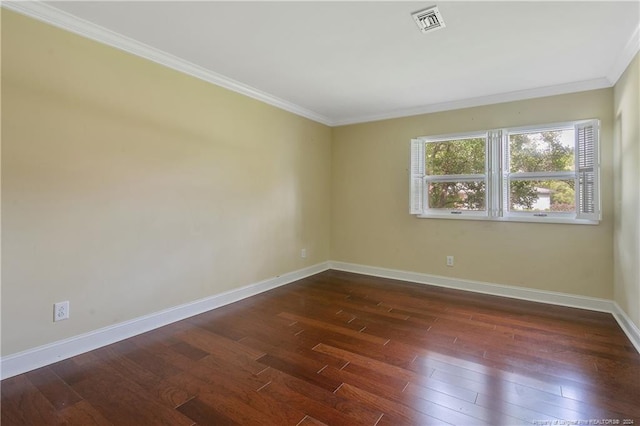 empty room featuring crown molding and dark hardwood / wood-style flooring