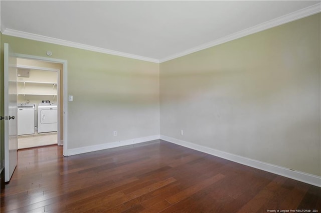 unfurnished room featuring crown molding, separate washer and dryer, and dark hardwood / wood-style flooring